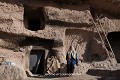 Aux premières heures de la journée, cette habitante assise devant sa maison profite d’un soleil encore doux ; village de Meymand (province de Kerman, Iran). Iran 
 Maymand 
 Meymand 
 UNESCO 
 creusé 
 grotte 
 habitat 
 patrimoine mondial 
 plateau iranien 
 province de Kerman 
 troglodyte 
 troglodytique 
 tuf volcanique 